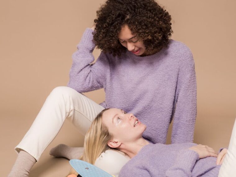 Positive young multiracial girlfriends relaxing after riding penny boards