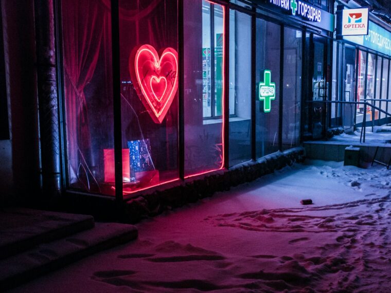 red and green neon light signages on building at nighttime